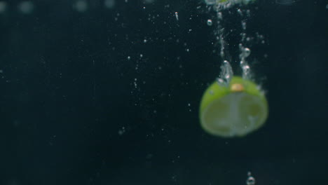 Lime-dropped-in-water-slow-motion.